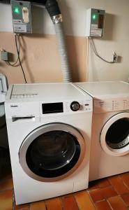 a white washing machine sitting next to a washer at Landhaus Herdt in Lauda-Königshofen