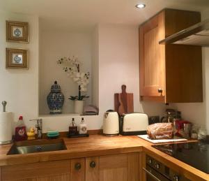 a kitchen with a sink and a counter top at Beautiful 1BR Apartment in Historic St Aubin House in Saint Aubin