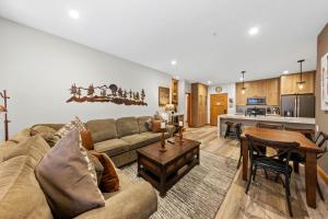 a living room with a couch and a table at Palisades Tahoe Lodge Rentals Premium Two Bedroom #700 in Olympic Valley