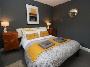 a bedroom with a large bed with two towels on it at Kestrel in Southwold