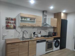 a kitchen with a sink and a stove top oven at Estudio completo familiar in La Jonquera