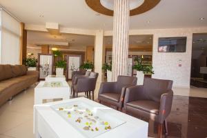 a lobby with couches and chairs and a table at Hotel Jana in Međugorje
