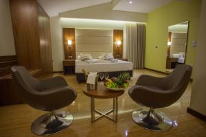 a hotel room with a bed and two chairs and a table at Hotel Jana in Međugorje