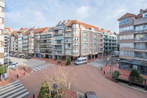 a large building with a parking lot in front of it at Girasol in Knokke-Heist