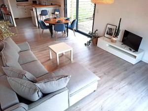 un soggiorno con un divano e un tavolo di NEW : Maison - 10mn La Bourboule a Choriol