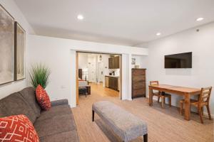 a living room with a couch and a table at Palisades Tahoe Lodge Rentals Premium Studio #252 in Olympic Valley