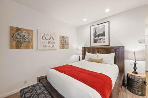 a bedroom with a large bed with a red blanket at Palisades Tahoe Lodge Rentals Premium Studio #252 in Olympic Valley