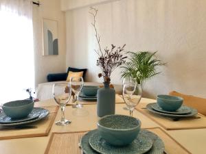 a dining room table with bowls and wine glasses at Apartamento a 400 metros da praia Santa Cruz in Santa Cruz +26 photos