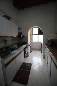 a kitchen with a sink and an archway in it at Apartamento Cómodo en el Poblado in Medellín