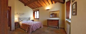 a bedroom with a bed and a dresser at Villa Brancatelli in Riotorto