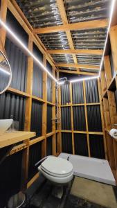 a bathroom with a toilet and a sink at Glamping Matanzas Lodge & Glamp in Matanzas