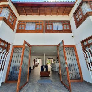 an open door into a house with a porch at La Huerta Hotel Boutique in Tibasosa