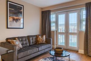 a living room with a couch and some windows at 2BED/2BATH Bliss, Private Parking in Windsor