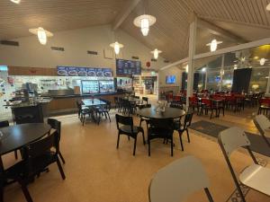 a dining room with tables and chairs in a restaurant at Rasta Falköping in Falköping