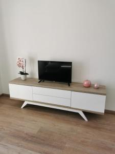 een woonkamer met een tv op een wit entertainmentcentrum bij Apartman Juric in Posušje