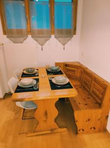a wooden table with plates and bowls on top of it at Appartement in St. Niklaus in Sankt Niklaus