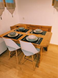 a dining room table with chairs and plates on it at Appartement in St. Niklaus in Sankt Niklaus