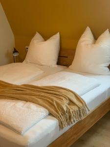 two beds with white sheets and a blanket on them at Gästehaus Reichmann in Beverungen