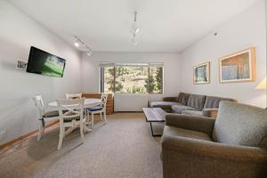 a living room with a couch and a table at Studio #247 in Olympic Valley