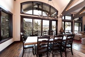 a dining room with a table and chairs and windows at 262 Sultan Drive in Durango Mountain Resort