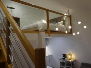 a bedroom with a bunk bed with lights on it at Apparts Watteau in Limoges