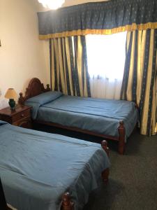 Giường trong phòng chung tại El Cortijo Apart - Hotel