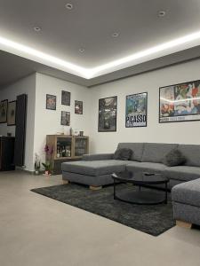 a living room with a couch and a coffee table at Sciara Casa Vacanze in Pedara