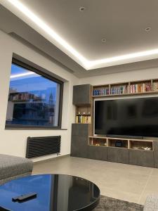 a living room with a large flat screen tv at Sciara Casa Vacanze in Pedara