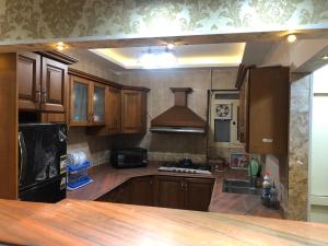 a kitchen with wooden cabinets and a stove top oven at شقه بحر مباشر العصافرة in Alexandria