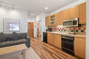 a kitchen with wooden cabinets and a couch in it at Studio #254 in Olympic Valley