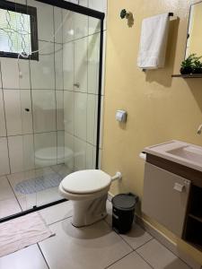 a bathroom with a shower and a toilet and a sink at Recanto da Serra in Pardinho