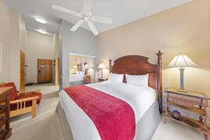 a bedroom with a large bed with a red blanket at Standard Room #816(B SIDE) in Olympic Valley
