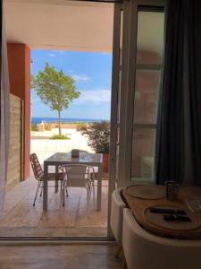 a room with a table and a patio with a view of the ocean at CAP ESTEREL, T2 VUE MER 4 couchages adapté PMR in Saint-Raphaël