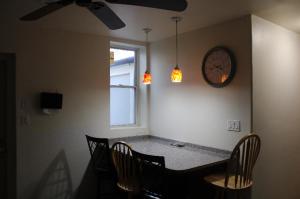 a dining room with a table and a clock on the wall at Private room in the heart of Oakland in Pittsburgh