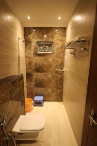 a bathroom with a toilet and a camera at Plazzo Prime Plaza in New Delhi