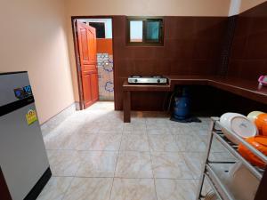 a small bathroom with a tile floor and a door at Boonsong Guest House in Khao Tao +33 photos