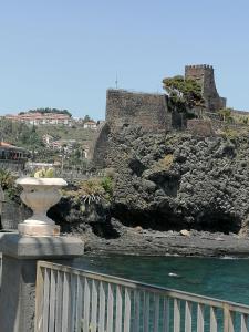 een standbeeld voor een kasteel en het water bij Donna Agata House in Catania