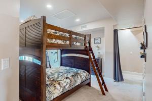 a bedroom with a bunk bed with a ladder at Bay Park Villa in San Diego