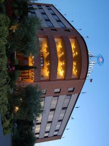 un edificio alto con luces encima en Hotel Forum, en Foiano della Chiana