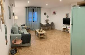 a living room with a couch and a table at Apartamentos Abadía. in Corella