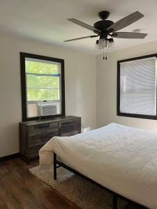 a bedroom with a bed and a ceiling fan at The Flying Dutchman Cottage in amenities filled Masthope community Ski Big Bear in Lackawaxen +29 photos