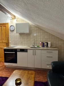 a kitchen with a sink and a stove at Apartmani Ivan in Kupres