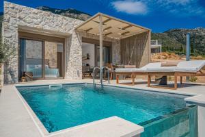 a villa with a swimming pool and a patio at Ionian Horizon - Private Bungalows in Plateies