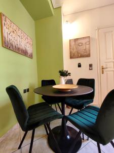 アテネにあるElia Apartmentsの緑の壁の部屋(テーブル、椅子付)