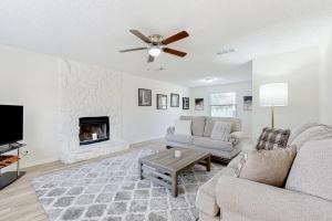 a living room with a couch and a fireplace at Piece of Paradise in Jacksonville Beach