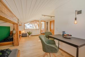 a living room with a table and chairs at Lichterberg in Hirschegg