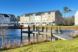 a wooden dock in the water in front of buildings at Sea Oaks Village 5 in Berlin