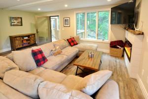 ein Wohnzimmer mit Sofa und Tisch in der Unterkunft SKI Bike, Hike & Golf Townhouse w/ Hot tub in Ellicottville