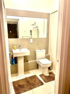 a bathroom with a sink and a toilet and a mirror at Chic studio in Leicester Sqaure! in London