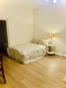 a bedroom with a bed and a table with a lamp at Chic studio in Leicester Sqaure! in London